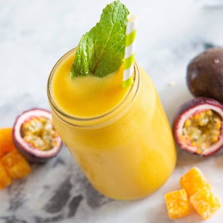 Frozen fruit yellow smoothie in mason jar