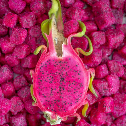 Frozen dragon fruit pieces surround fresh dragon fruit